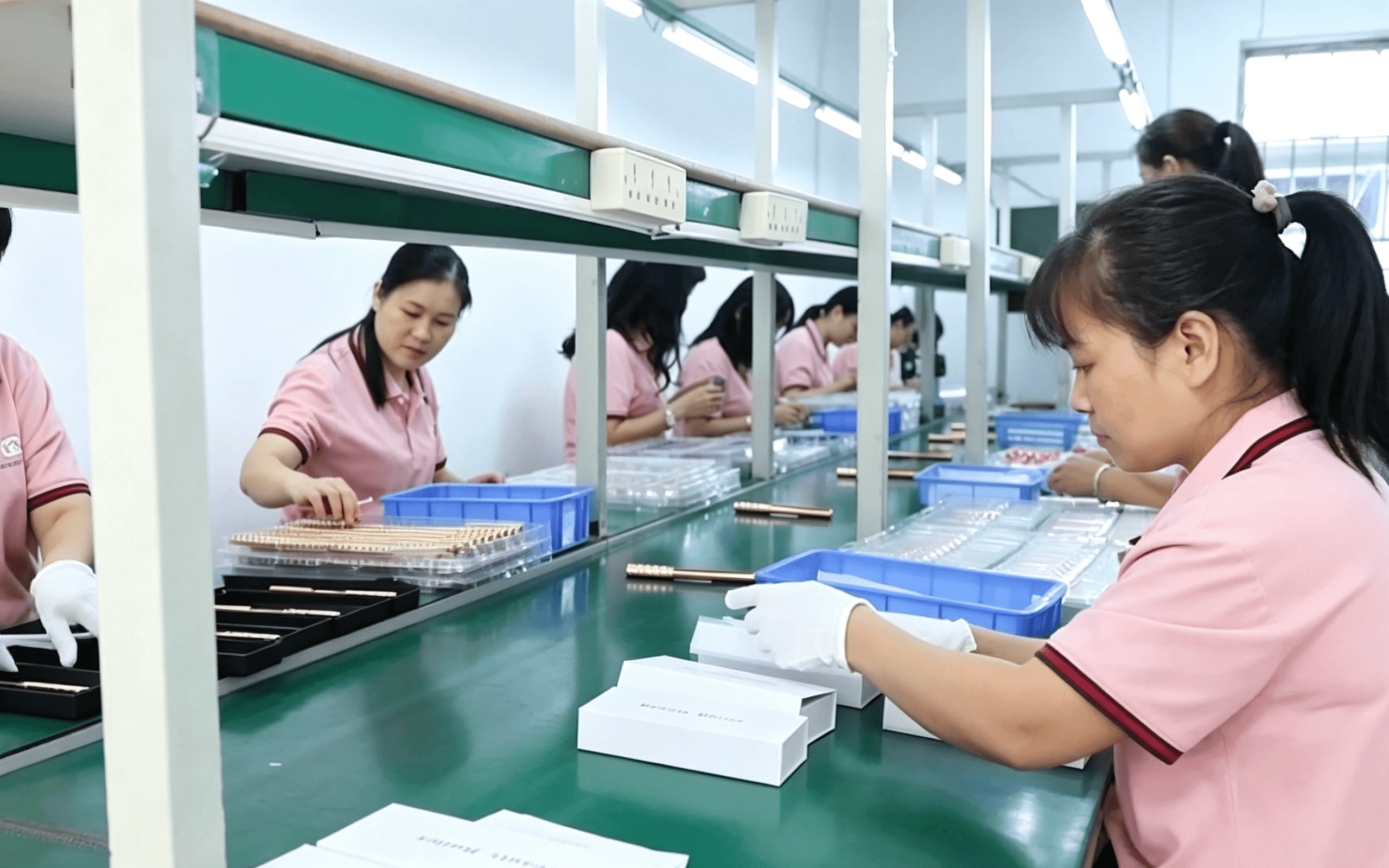 Team members working on the beauty tool production line